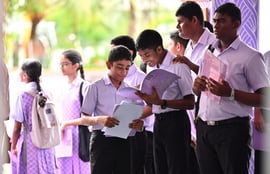 Some school students checking their report books — Photo: Nishan Ali/ Mihaaru