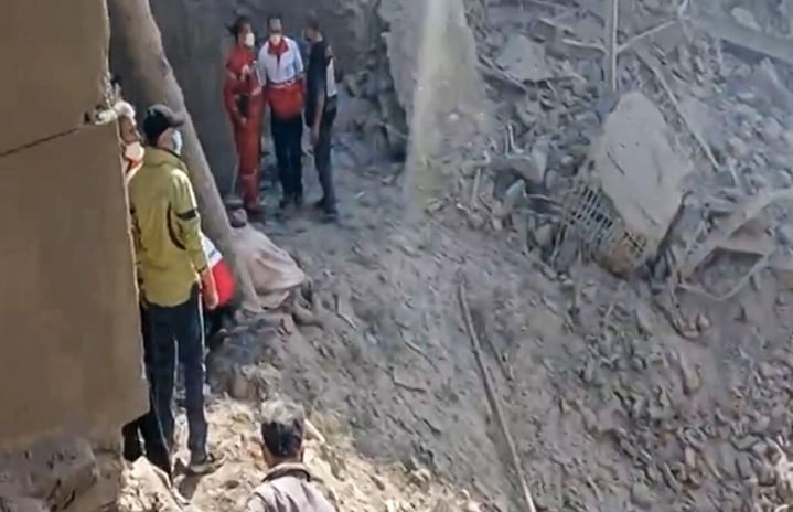 This video grab taken from UGC images posted on social media on February 28, 2026 and verified by AFPTV teams in Paris shows people inspecting the damage at an impact site following US and Israeli strikes on Tehran. The United States and Israel launched strikes against Iran on February 28, sparking fears of regional war with explosions reported across the Middle East as the Islamic republic retaliated with barrages of missiles.